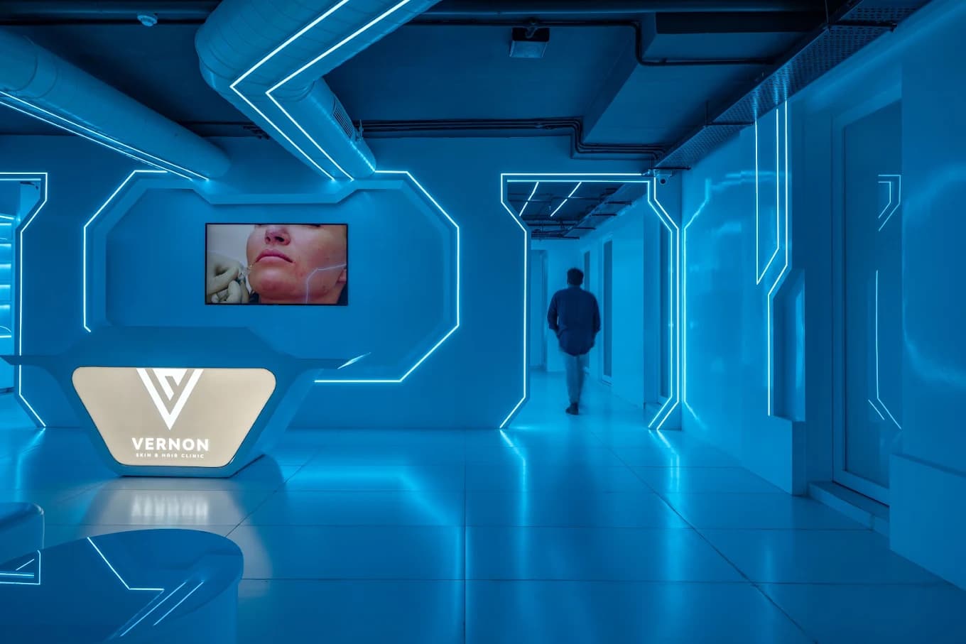 Vernon Clinic โ futuristic blue-lit reception lobby